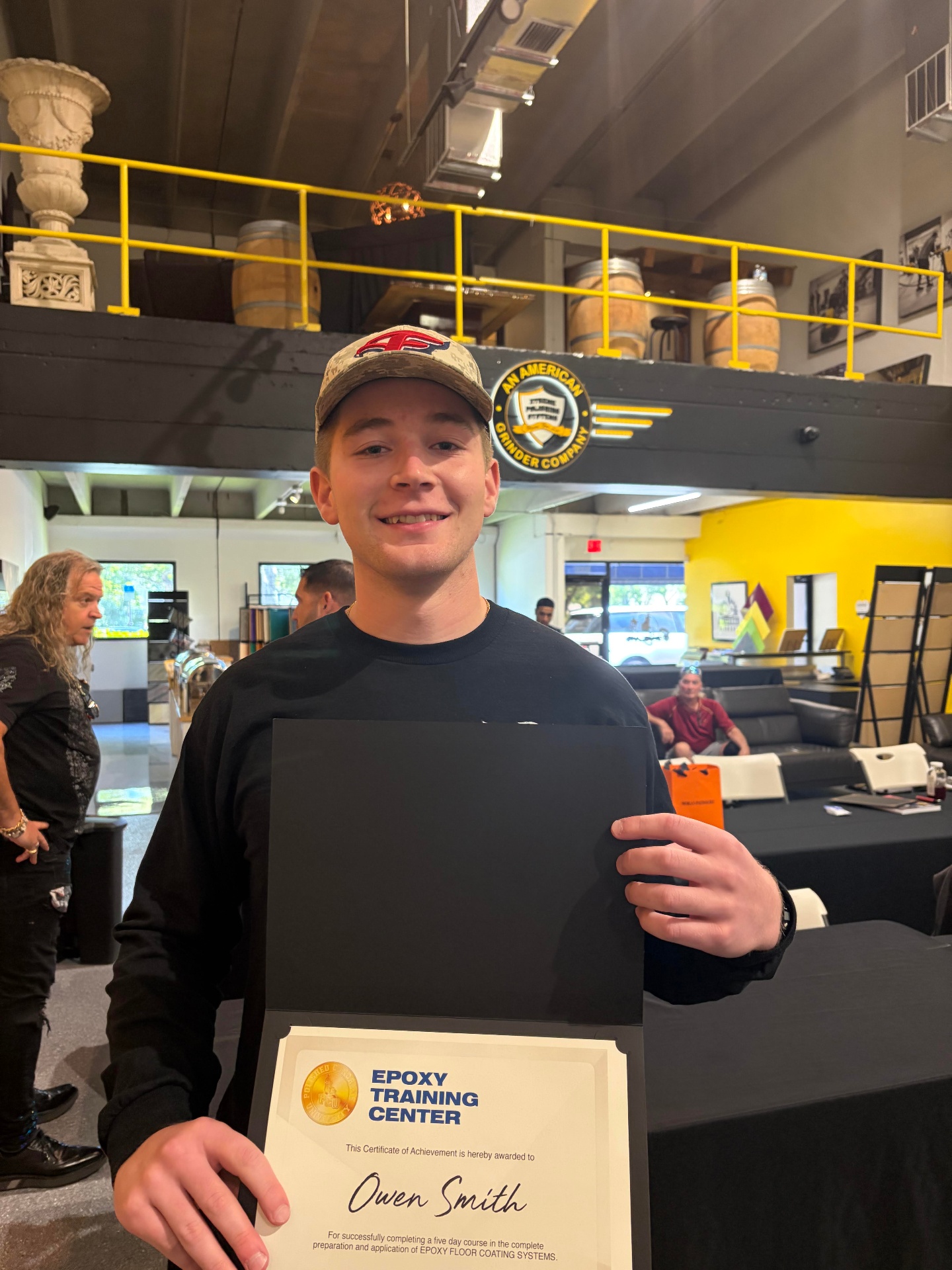 Eagle Epoxy owner holding an epoxy training certificate